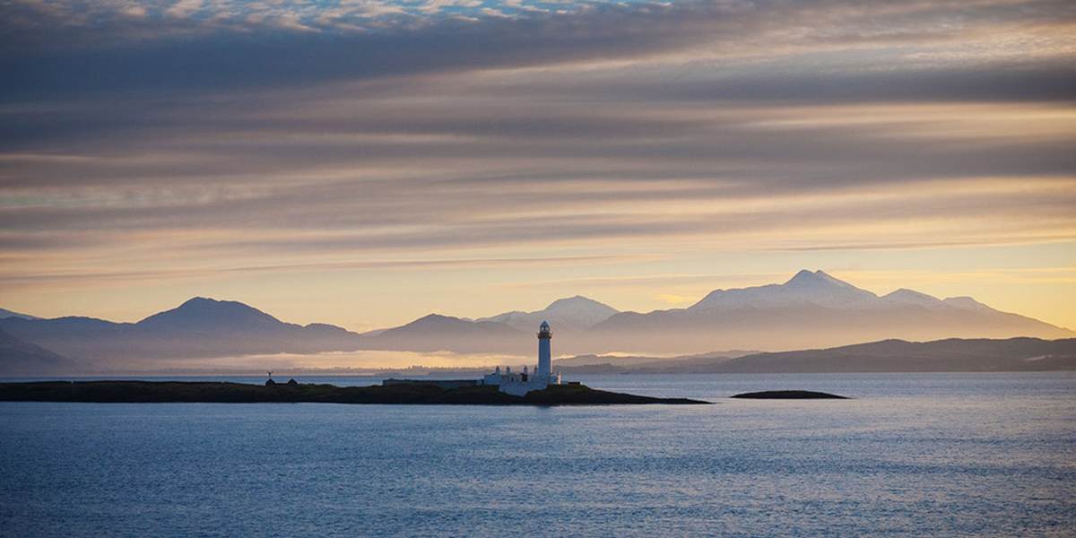 Lismore lighthouse with the mainland mountains in the distance - getting to Mull is a scenic experience 