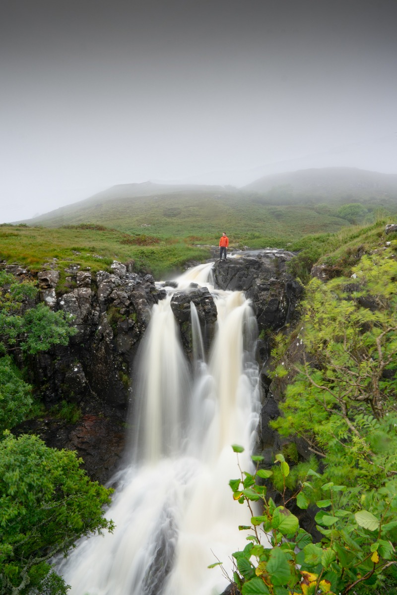 Eas Fors waterfall with man stood at the top