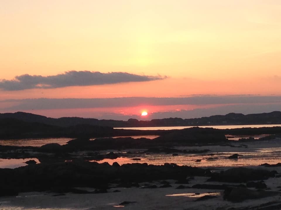 Fidden Beach rocks and pools with the tide out at sunset with an orange sky - one of the best times to photograph islands beaches on Mull