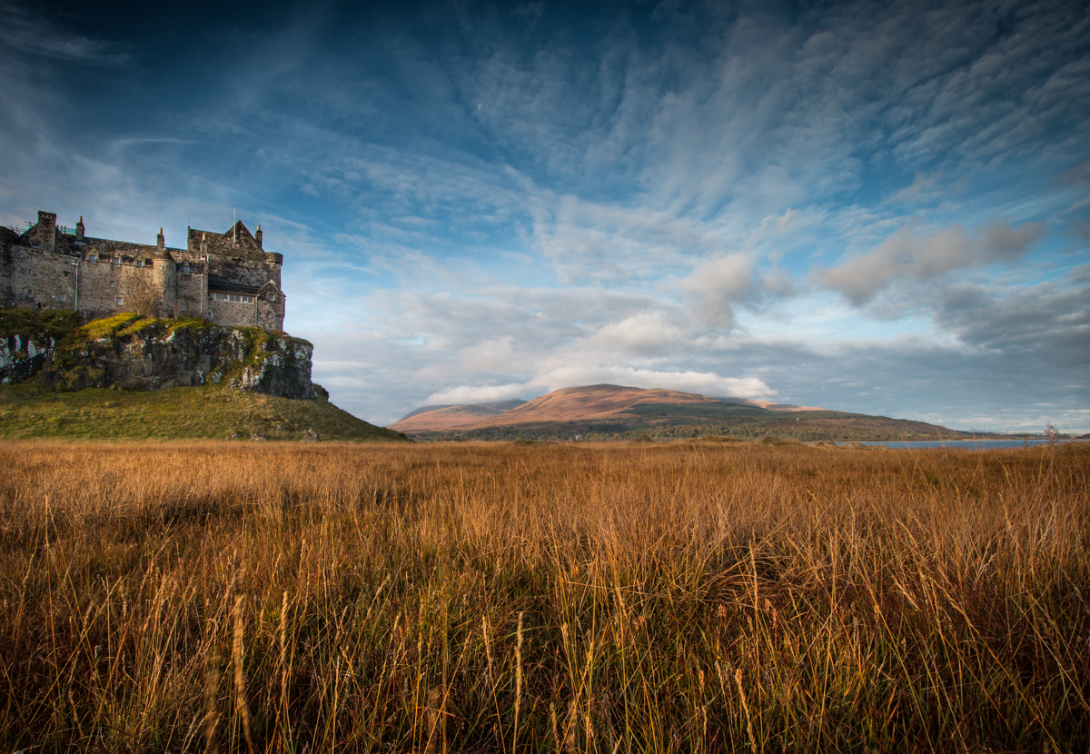 Duart Castle on the headland in south east Mull, surrounded by hills and fields in autumn