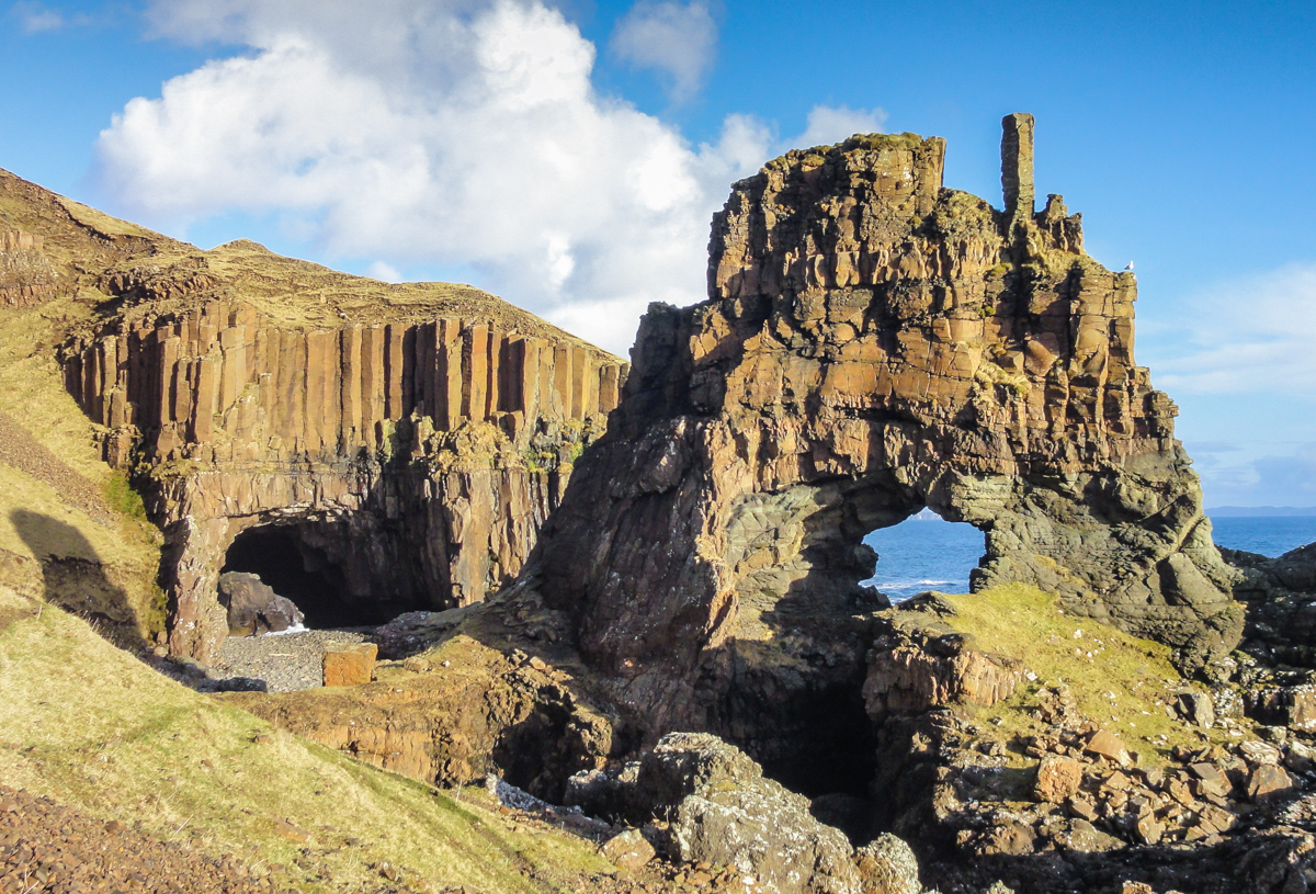 Carsaig Arches in blue sky and sunshine, low tide.