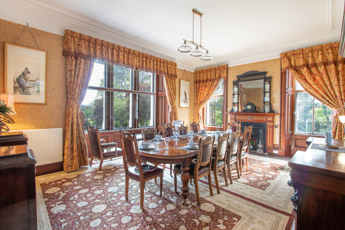 Magnificent dining room at Oakfield House in Tobermory with antique furniture and sea views from the window