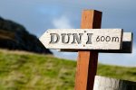A sign for the walk up Dun I the highest point on Iona at 101 meters