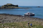Visitors heading back to the boat across boulder beach on Lunga