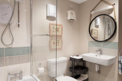 Contemporary bathroom with bath, electric shower, basin and w.c.