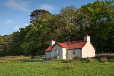 Tigh na Mara's stunning setting, backed by woodland and looking out over Loch Spelve
