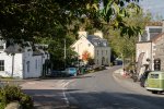 Middle of the village, with turning on the left towards the west coast and Loch na Keal