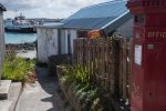 The post office on Iona with the ferry turning in the background