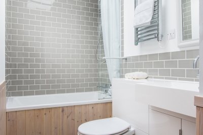 Family bathroom with bath and shower over