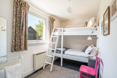 Bunk beds in the bedroom to the rear of the cottage