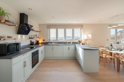 The modern kitchen also makes the most of the superb sea views