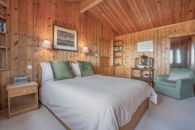 Spacious master bedroom that is comfortably furnished and full of character