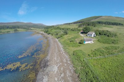 The Bothy and Dorran positioned by the coastline