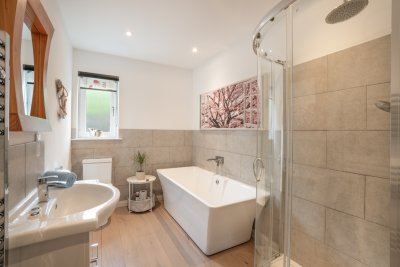 Family bathroom on the ground floor with deep bath and large walk in shower