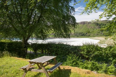 Private garden area surrounding the cottage with picnic bench