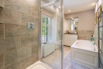 The inviting en-suite to the master, with walk-in shower and bath tub