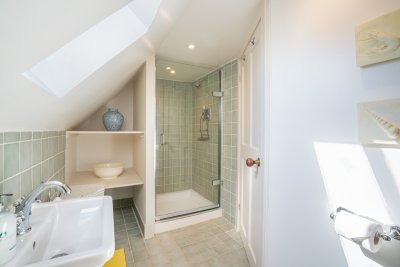 This compact shower room with low ceiling serves the second floor double and twin bedrooms