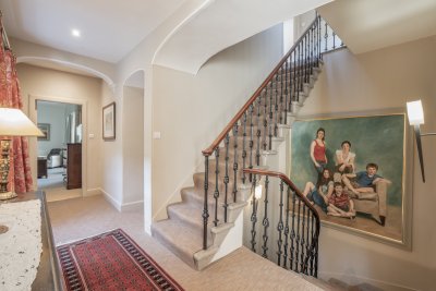 Ascend the stairs to the top floor of the property