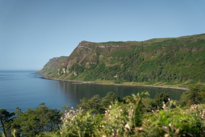 Walk along the black sand beach or hike to the Carsaig Arches