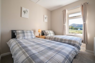 The cosy twin bedroom enjoys rural views