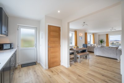 Natural light fills the cottage while large windows make the most of the sea views