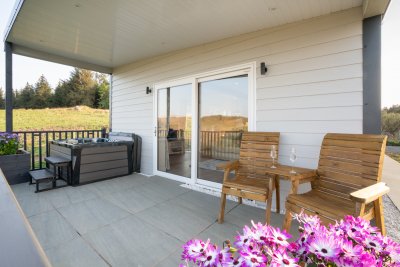 Enjoy a fully covered deck with bubbling hot tub