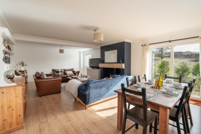The dining area sits at one end of the living room