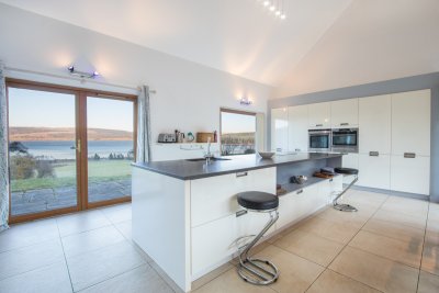 Sleek fitted kitchen, well equipped for guests