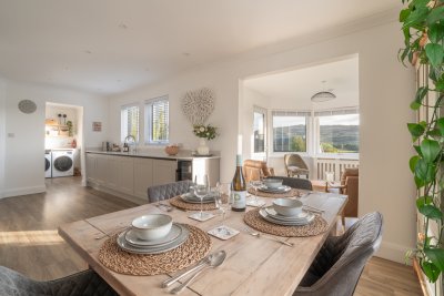 Looking across the dining area to the kitchen and sun room