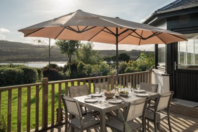 Enjoy dinner alfresco as the sun sets over the loch