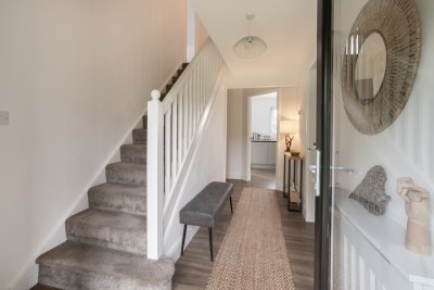 A staircase leads to two further double bedrooms