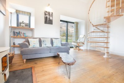 Living room with doors to garden and spiral staircase