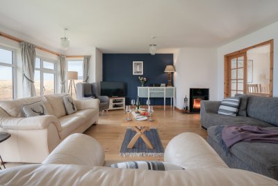 The spacious living room with cosy wood-burning stove