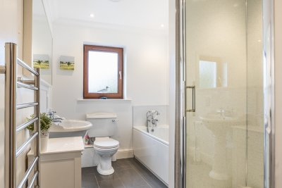 With large shower unit, bath and heated towel rail 