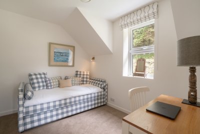 The cosy single bedroom, which doubles as an office space