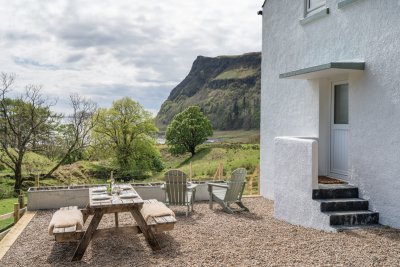A few steps lead up to the door from the garden area