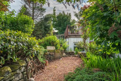 A small garden area with a mix of gravel terraces and planting