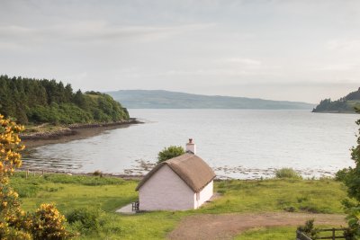 A house with a spectacular setting (now with a post and rail fence enclosing the garden)