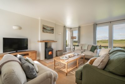 Triple aspect windows fill the living room with natural light