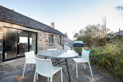 Rear patio at the property with BBQ and seating area