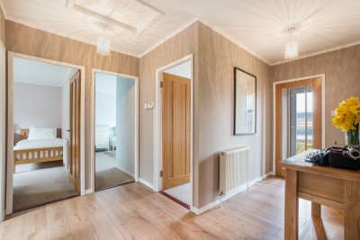 Central hallway with doors leading to front garden and patio