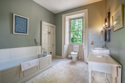 This elegant bathroom serves as the en-suite to the master bedroom