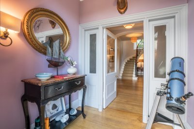 The impressive telescope and antique console table set the tone for the treasures to come