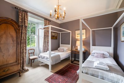 One of two twin bedrooms, this one with four-poster beds