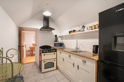 Looking down the galley kitchen from beside the patio doors