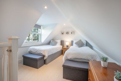 The twin bedroom has coombed ceilings and sea views