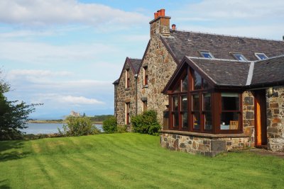 Lawned area wraps around the house, shared with Coach House guests