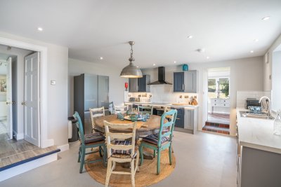 The kitchen, with step up to the utility room and steps up to the dining room