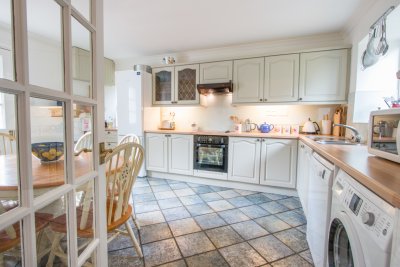 Looking into the kitchen with a sociable breakfast table