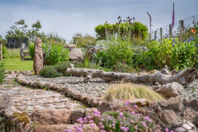 Maple Cottage's garden includes pretty planting and outdoor seating